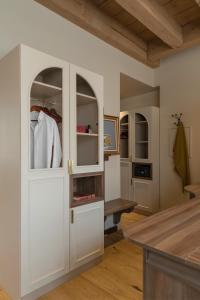 a kitchen with white cabinets and a table at Académie Hôtel Lyon in Lyon