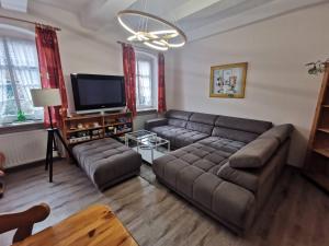 a living room with a couch and a flat screen tv at Grenzstübchen in Hötensleben