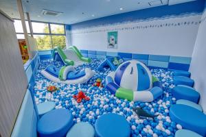a play room with blue balls and slides at Ooedo Onsen Monogatari Premium Toba Saichoraku in Toba