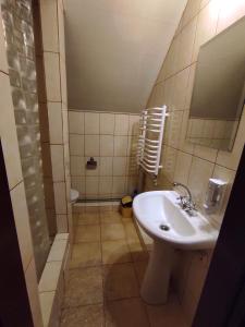 a bathroom with a sink and a shower at Motel M19 in Lipiny