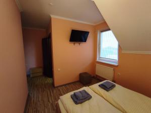 two beds in a room with two towels on them at Motel M19 in Lipiny