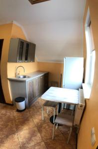 a small kitchen with a table and a sink at Motel M19 in Lipiny +2 photos