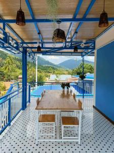a dining room with a table and blue ceilings at Khaosok Bluesky Hotel in Khao Sok National Park