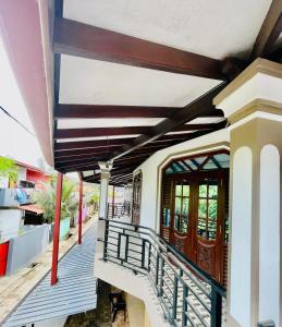 a balcony of a house with a staircase at Aamy Luxury Villa in Galle