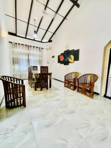 a dining room with wooden chairs and a table at Aamy Luxury Villa in Galle