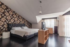 a bedroom with a bed and a tv in it at Hotel Bruman in Caserta