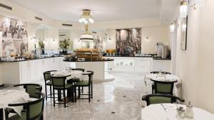 a restaurant with tables and chairs and a counter at Hotel Johann Strauss in Vienna
