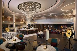 a rendering of a hotel lobby with tables and chairs at Renaissance Shanghai Hongqiao in Shanghai
