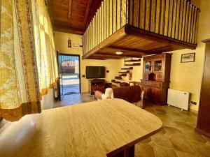 a living room with a wooden table and a living room at La Casa di Ori in Castel SantʼElia