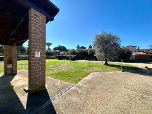 a brick pillar of a building with a park in the background at La Casa di Ori in Castel SantʼElia