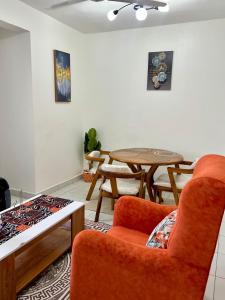 a living room with a table and a chair at Leona Homes in Mombasa