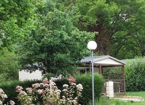 a gazebo in the middle of a garden at ZEcamping 3 pataugeoire animations locatif TV BBQ 24m2 4 pers in La Souterraine