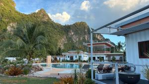 a view of a resort with a mountain in the background at This Great Place in Don Sak