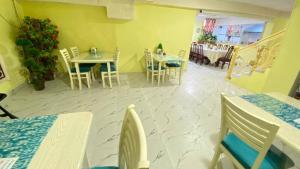 a room with tables and chairs and a dining room at Samarkand Сity Guest House in Samarkand