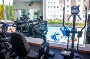 a gym with rows of exercise bikes in front of a window at Leona Homes in Mombasa