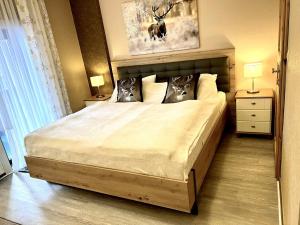 a bedroom with a large bed with two pillows at Zimmer Nr 4 im Haus Sabine in Braunlage