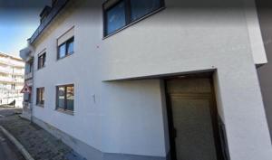a white building with a door on the side of it at Orange Suite Bad Säckingen in Bad Säckingen