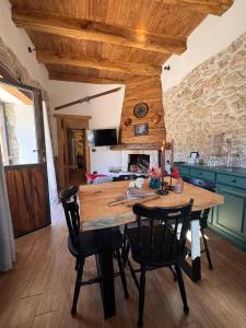 a dining room with a wooden table and chairs at Dimore Di Charme Lago Matese in San Gregorio