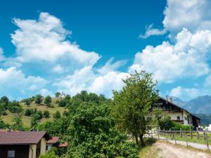 a house on the side of a hill with a tree at Property in Kirchbichl in Kirchbichl