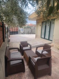 a group of chairs and tables on a patio at Apartment 2 by Villa Ceni in Elbasan +1 photo