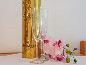 a bottle of champagne and two champagne glasses and flowers at Property in Kirchbichl in Kirchbichl +42 photos