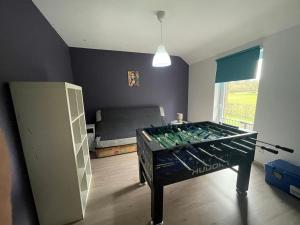 a room with a bed and a foosball table at Barsy La belle des champs in Havelange +13 photos