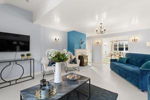 a living room with a blue couch and a table at Northbrook in Tackley