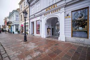 a street with shops and a street light on a sidewalk at AR Golden House II in Košice