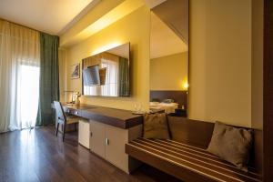 a hotel room with a bench and a mirror at AR Golden House II in Košice