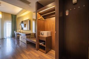 a room with a kitchen and a desk with a microwave at AR Golden House II in Košice +18 photos