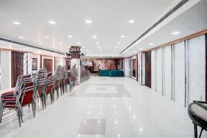 a corridor with chairs and tables in a building at Hotel O Govind Nagar Kanpur Formerly Maharoopa Palace in Kānpur
