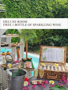 a table with a buffet of food and a bottle of sparkling wine at Treevana Club Chiangmai in Chiang Mai