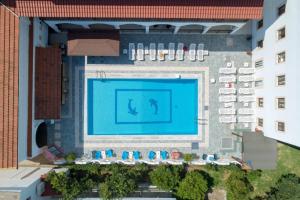 an overhead view of a swimming pool in a building at on the STRIP studio 3 in Kavos