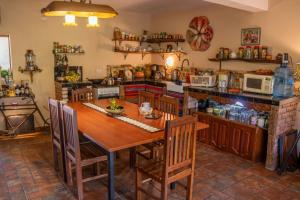 a kitchen with a wooden table and a kitchen with appliances at Cabaña Renacer in Samaipata
