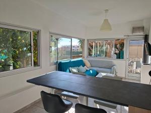 a kitchen and living room with a table and chairs at Chez Anne in La Ciotat