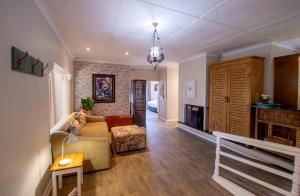 a living room with a couch and a fireplace at The Paper Fig House in Plettenberg Bay