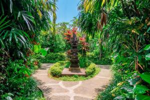a garden with a statue in the middle of a path at Bali Dream Garden - Tropical Escape with Pool & Spa in Ubud +269 photos