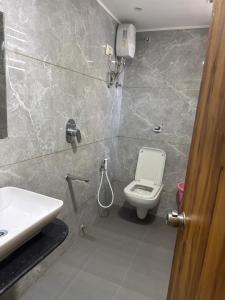 a bathroom with a toilet and a sink at hotel belva in Ahmedabad