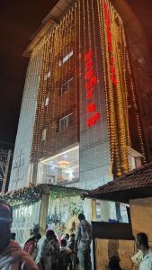 a group of people standing in front of a building at COMFORT Inn in Subrahmanya