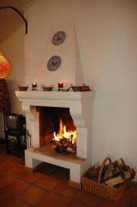 a fireplace in a living room with a fire at Cal Caterino in Montsonis