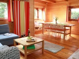 a living room with a table and a dining room at Chata Sova Tále in Bystrá