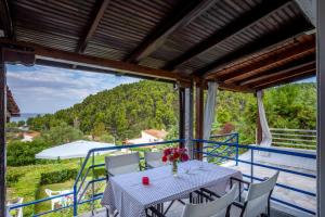 a table and chairs on a balcony with a view at Onar holiday home in Fourka