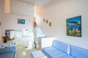 a living room with a blue couch and a staircase at Onar holiday home in Fourka