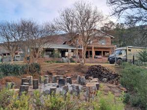 a house with a cemetery in front of a house at Sheeprun Farmstay in Maclear
