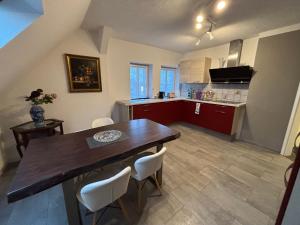 a kitchen and dining room with a wooden table and chairs at Villa Blue Max in Großenhain