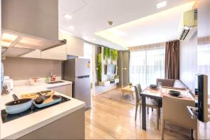 a kitchen and dining room with a stove and a table at Dazzle Residence Sukhumvit Bangkok in Bangkok