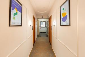 a hallway in a hospital with paintings on the walls at Treebo Alfa Suites in Mumbai