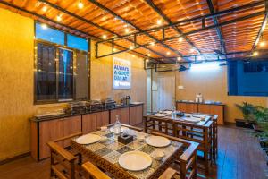 a restaurant with tables and chairs in a room at Treebo Alfa Suites in Mumbai