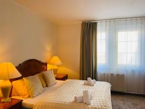 a bedroom with a bed with two towels on it at DAEGA with daehan in Žilina