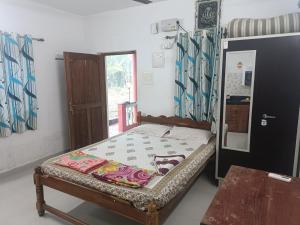 a small bed in a room with a window at Serene Green Park in Canacona